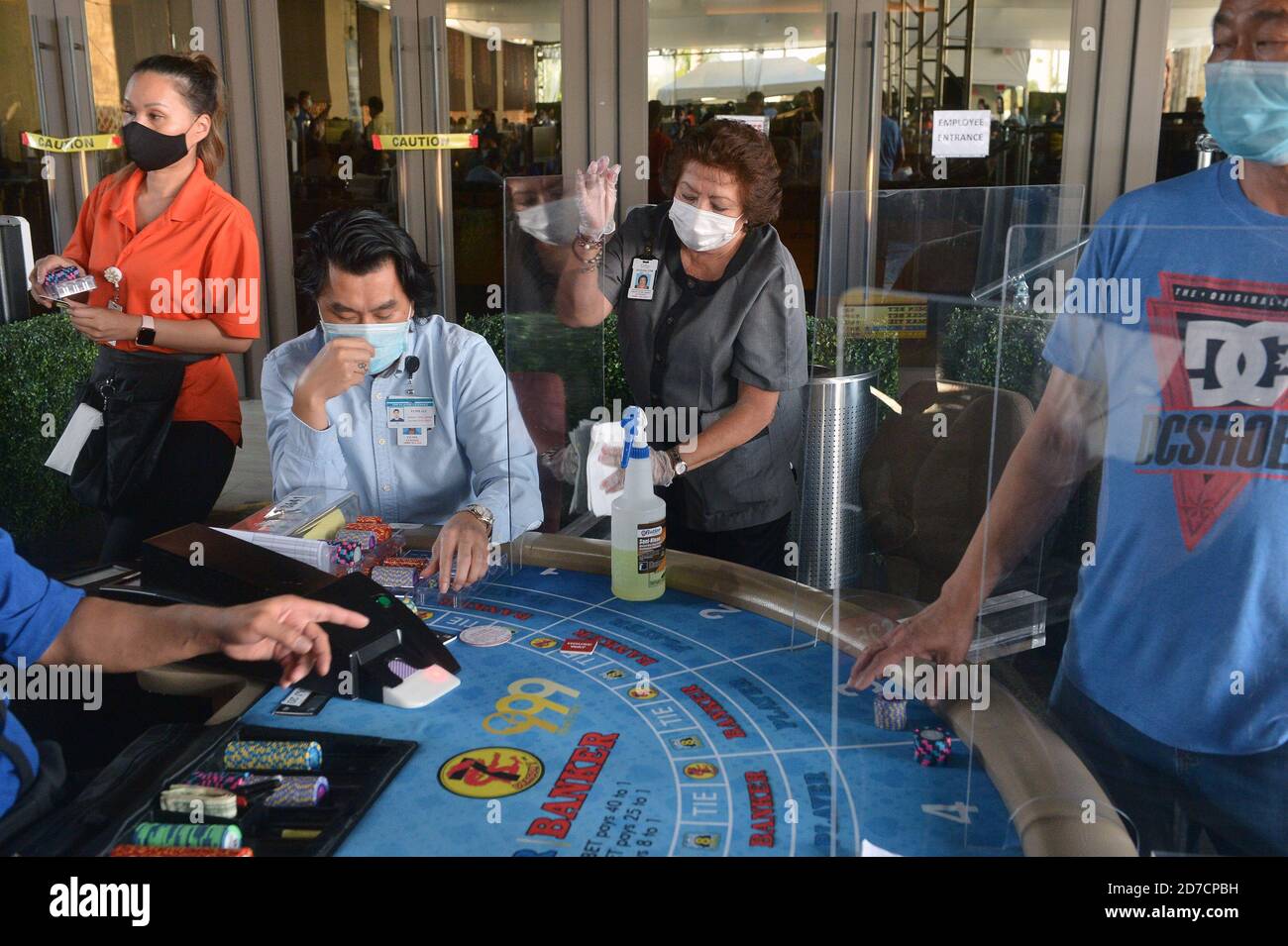 Hawaiian Gardens, United States. 22nd Oct, 2020. A worker sanitizes a partition at one of 45 card tables in what used to be the valet area of Gardens Casino in Hawaiian Gardens, California on Wednesday, October 21, 2020. Partitions and seats are sanitized each time a customer gets up tp prevent the spread of the coronavirus. Card clubs in Los Angeles County reopened in early October with health precautions, drawing a stream of gamblers and expressions of relief from city leaders who have struggled without the key source of tax revenue. Photo by Jim Ruymen/UPI Credit: UPI/Alamy Live News Stock Photo