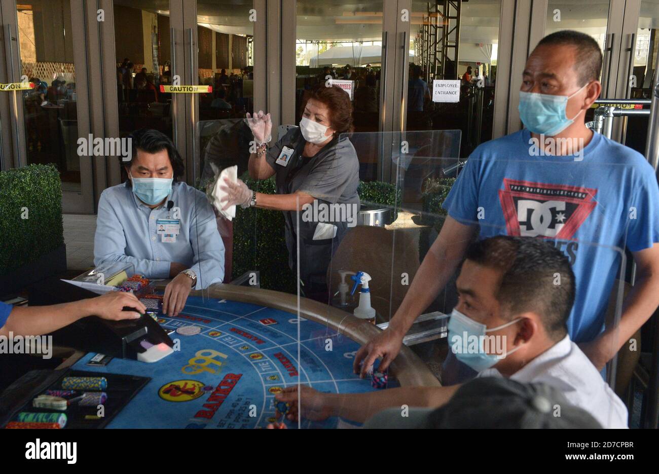 Hawaiian Gardens, United States. 22nd Oct, 2020. A worker sanitizes a partition at one of 45 card tables in what used to be the valet area of Gardens Casino in Hawaiian Gardens, California on Wednesday, October 21, 2020. Partitions and seats are sanitized each time a customer gets up tp prevent the spread of the coronavirus. Card clubs in Los Angeles County reopened in early October with health precautions, drawing a stream of gamblers and expressions of relief from city leaders who have struggled without the key source of tax revenue. Photo by Jim Ruymen/UPI Credit: UPI/Alamy Live News Stock Photo