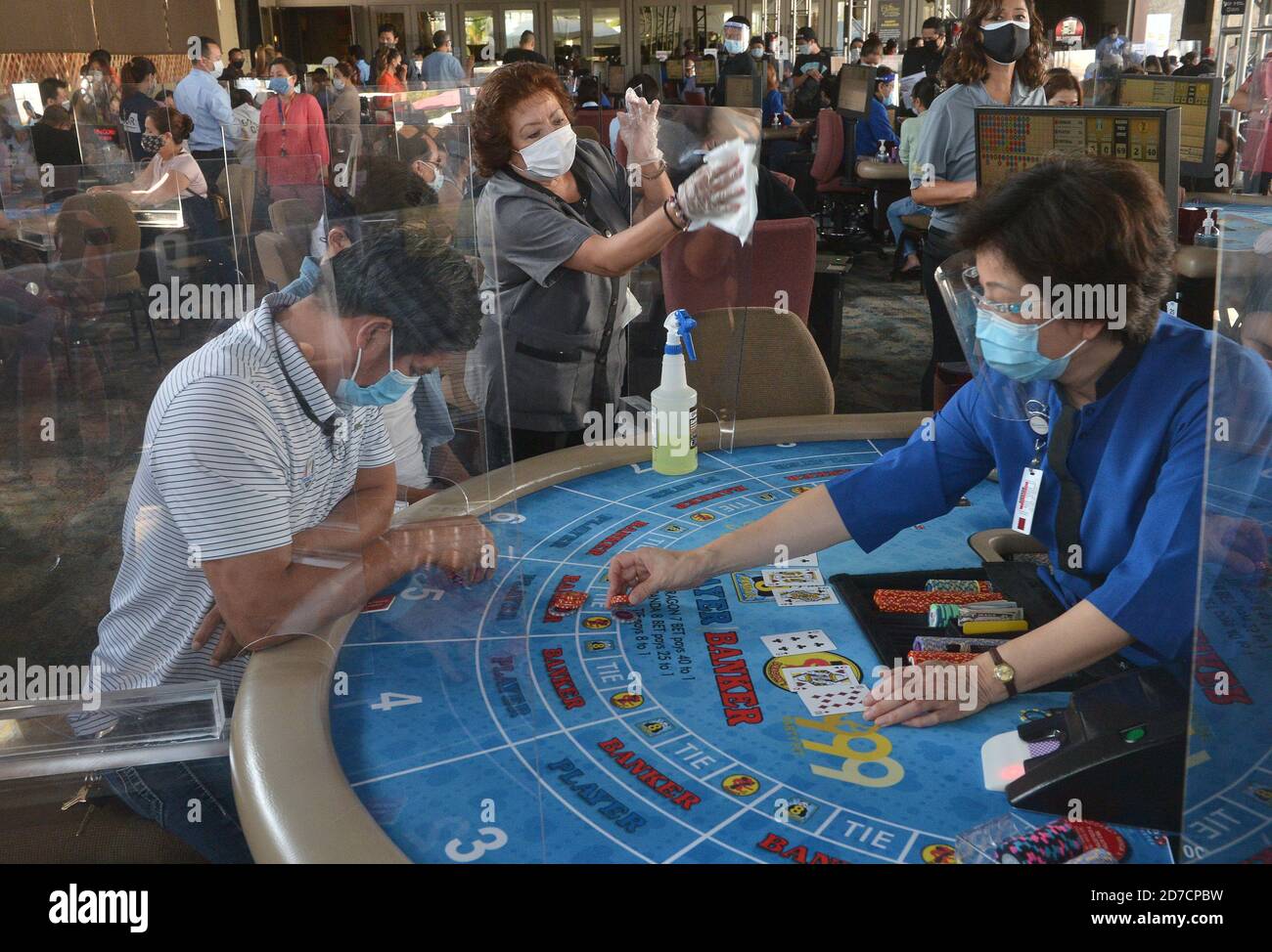 Hawaiian Gardens, United States. 22nd Oct, 2020. A worker sanitizes a partition at one of 45 card tables in what used to be the valet area of Gardens Casino in Hawaiian Gardens, California on Wednesday, October 21, 2020. Partitions and seats are sanitized each time a customer gets up tp prevent the spread of the coronavirus. Card clubs in Los Angeles County reopened in early October with health precautions, drawing a stream of gamblers and expressions of relief from city leaders who have struggled without the key source of tax revenue. Photo by Jim Ruymen/UPI Credit: UPI/Alamy Live News Stock Photo