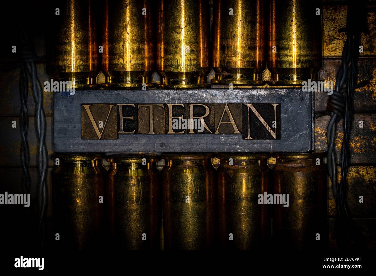 Veteran text message transposed on lead bars over copper 50 caliber gun casings on vintage textured grunge copper and gold background Stock Photo