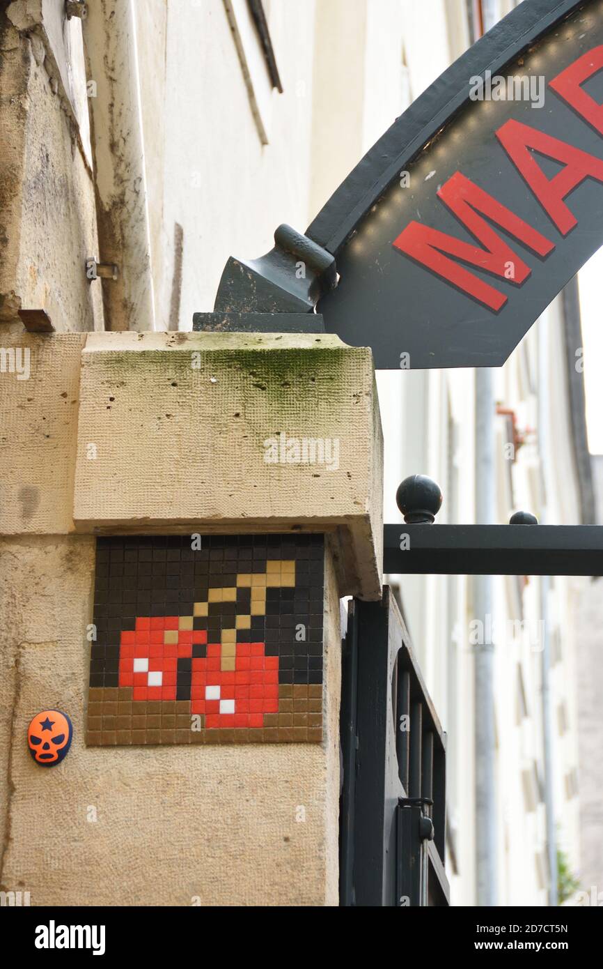 Paris, France. Ceramic tile pixelated art by the unknown French urban street artist in front of Le Marche des Enfants Rouges the oldest covered market Stock Photo