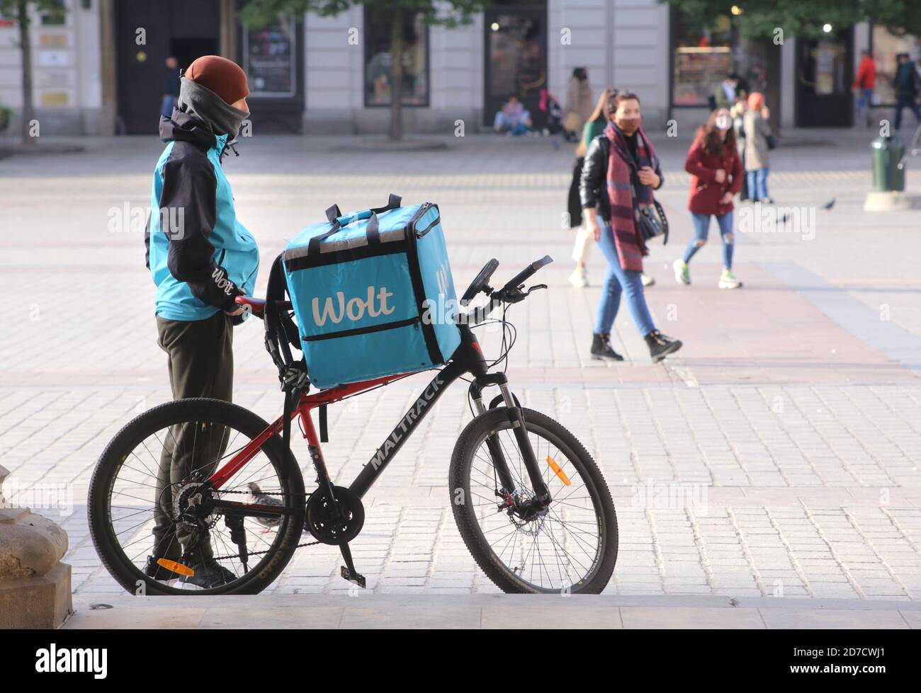 Cracow. Krakow. Poland. Bike food delivery courier. Second wave of coronavirus pandemic. Stock Photo