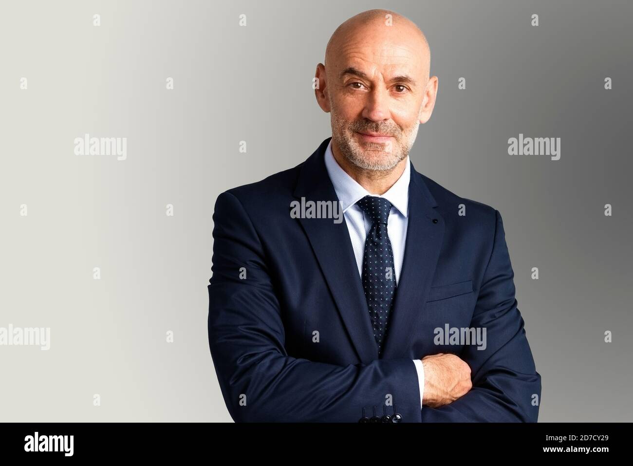 Studio portrait of middle aged businessman wearing suit and tie while ...