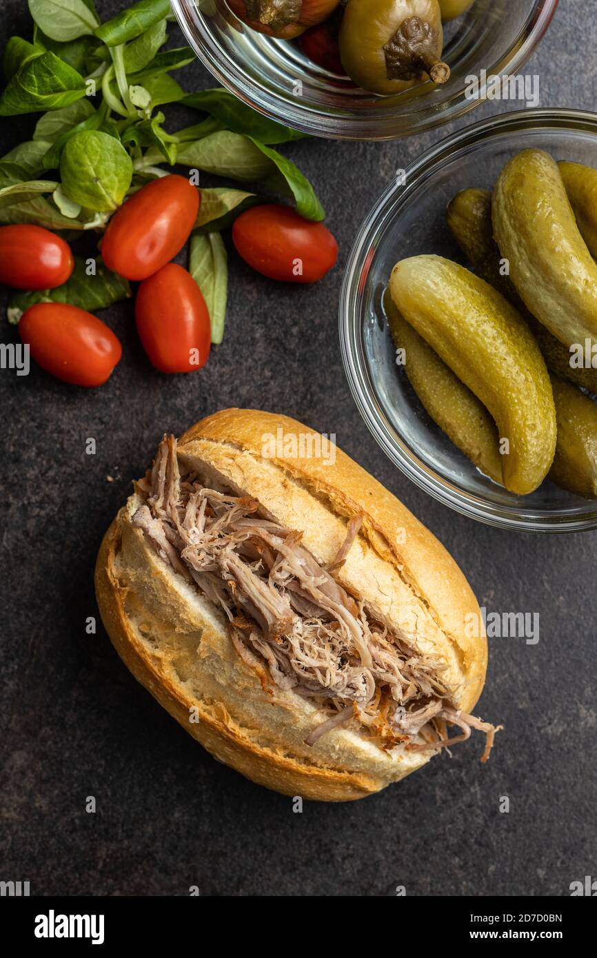 Sandwich with pulled meat on black table. Top view. Stock Photo