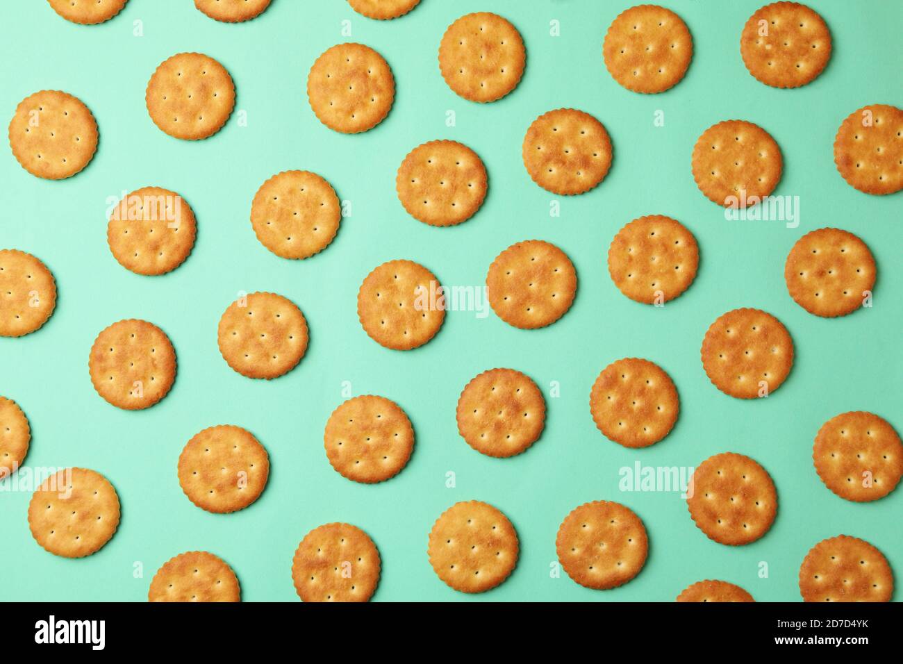 Flat lay with cracker biscuits on mint background Stock Photo