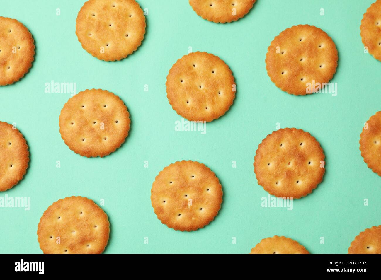 Flat lay with cracker biscuits on mint background Stock Photo