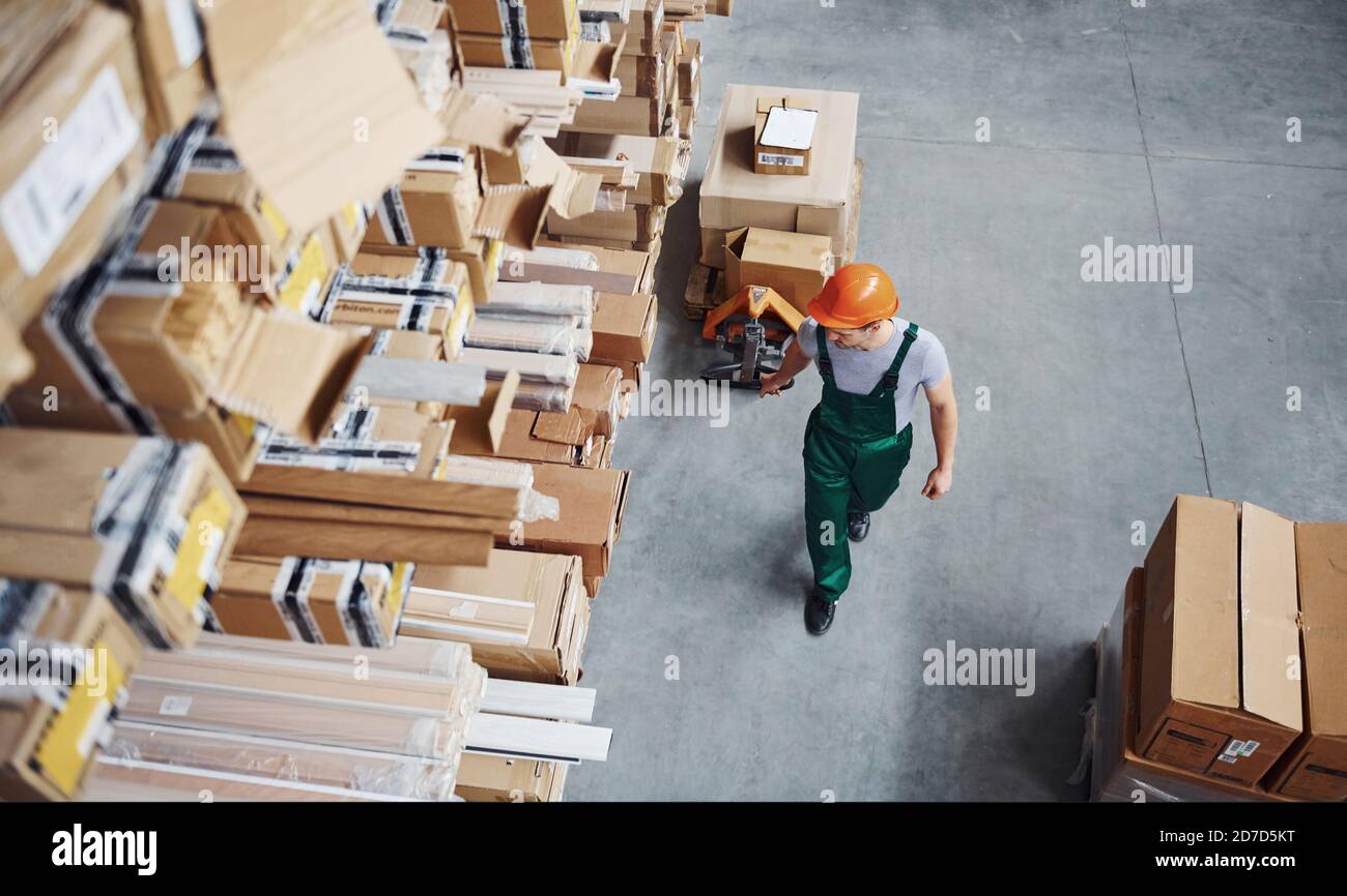 Top view of male worker in warehouse with pallet truck Stock Photo - Alamy