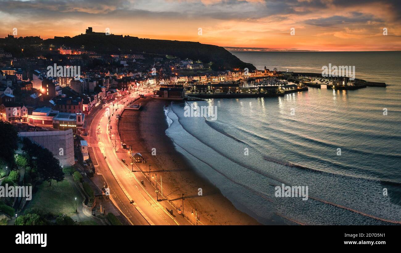 Dawn over the castle and the south bay at Scarborough on the North Yorkshire coast. Stock Photo