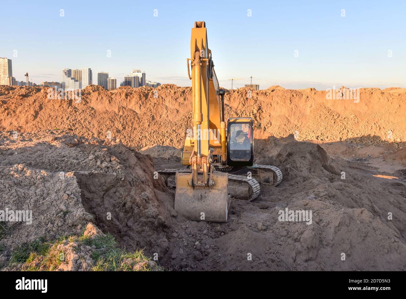 Large excavator working at construction site. Backhoe during earthworks ...