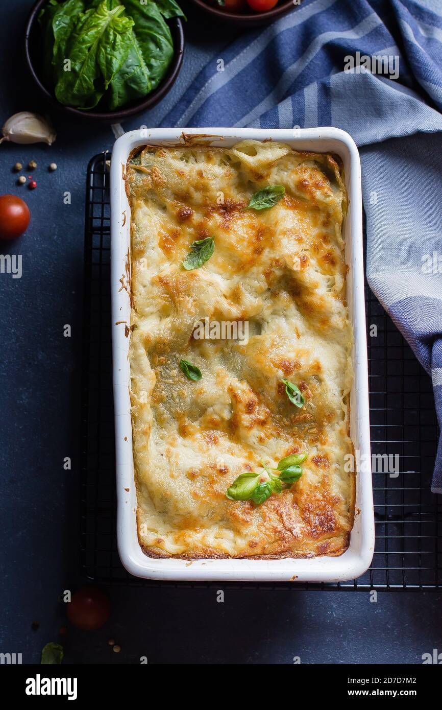 Delicious homemade lasagne with ricotta cheese and spinach on blue ...