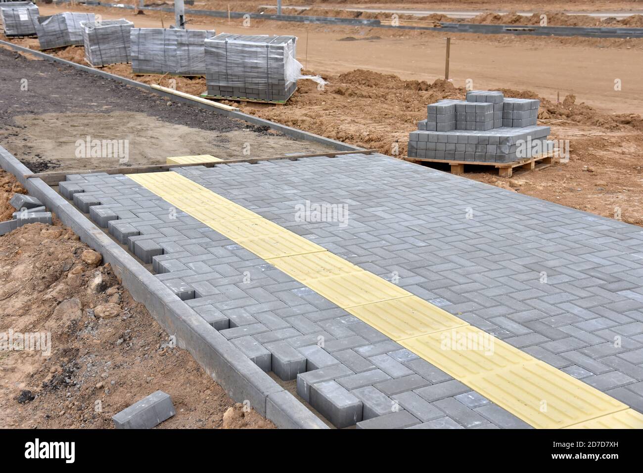 Laying paving slabs at construction site. Process of installing paving