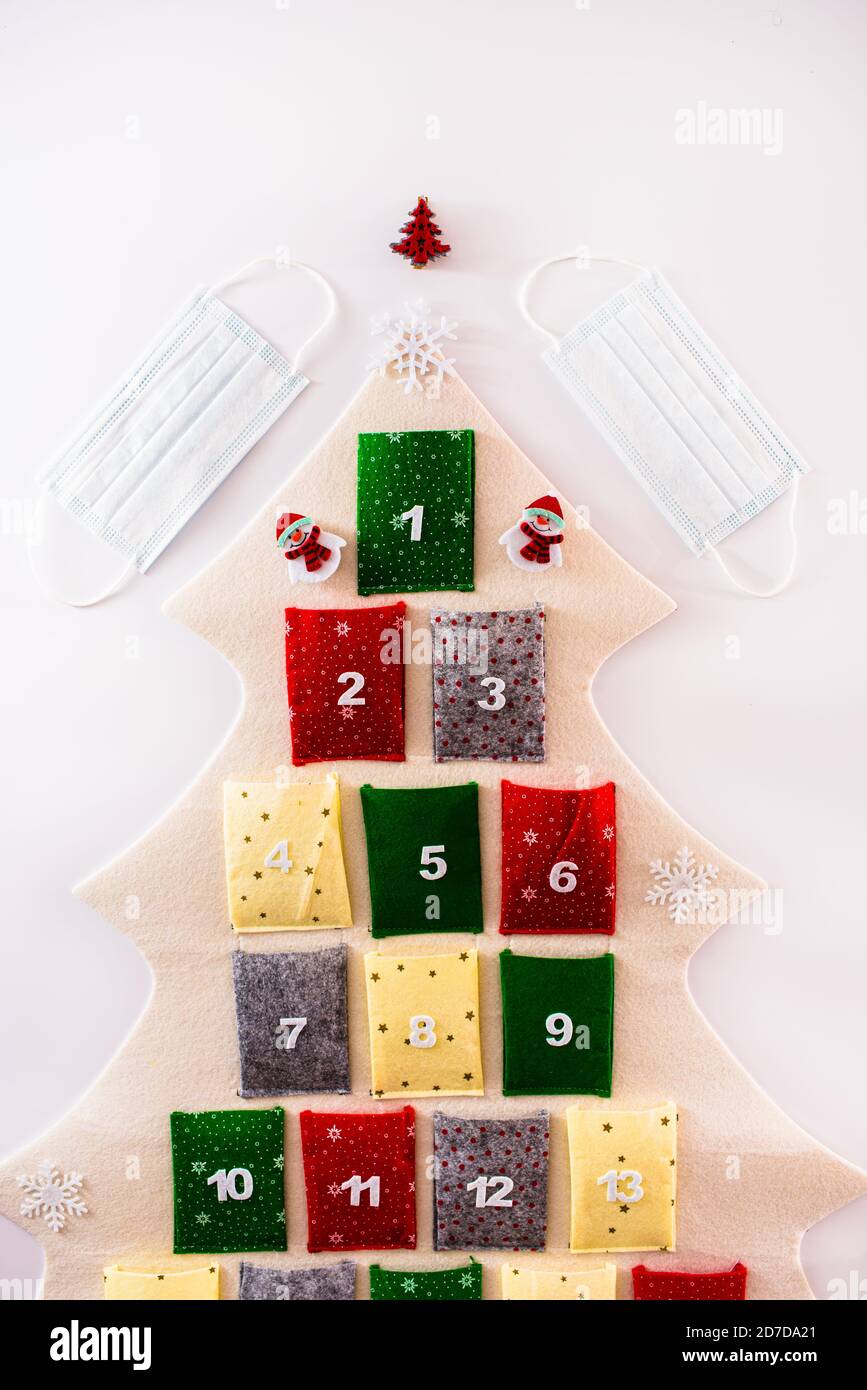 Traditional advent calendar protected with medical face masks, isolated