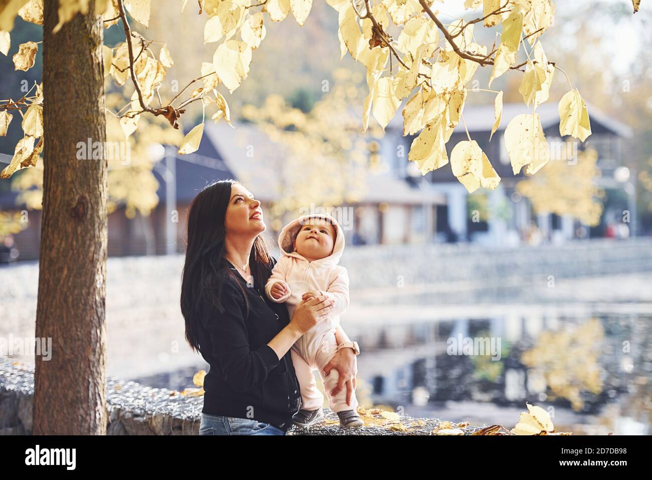 Mother in casual clothes with her child is in the park Stock Photo