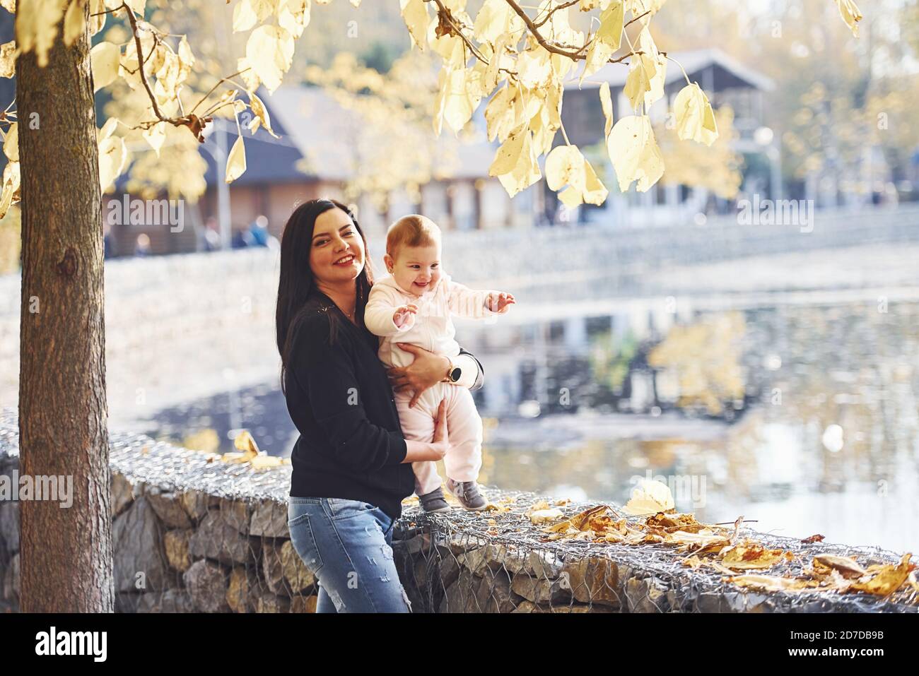Mother in casual clothes with her child is in the park Stock Photo