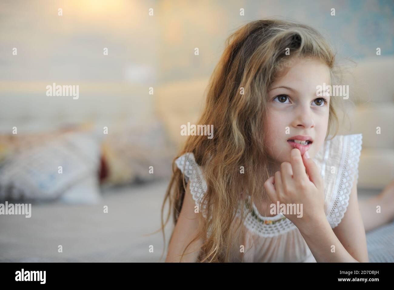 Lazy Small Caucasian Girl Lying In Bedroom At Home Watching Online Tv Broadcast With Interest 