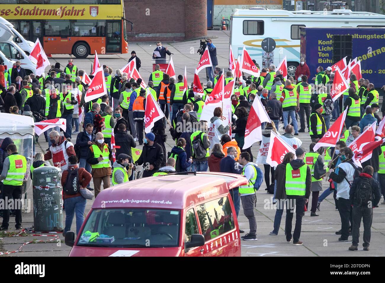 22 October 2020, Hamburg: Participants stand together at a rally in the  fish market as part of a warning strike by the trade union Verdi. The Verdi  union has called on public