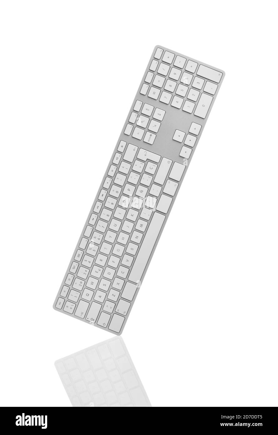 Keyboard upright in a graceful balance with a soft reflection against white background. Clipping path on keyboard. Stock Photo