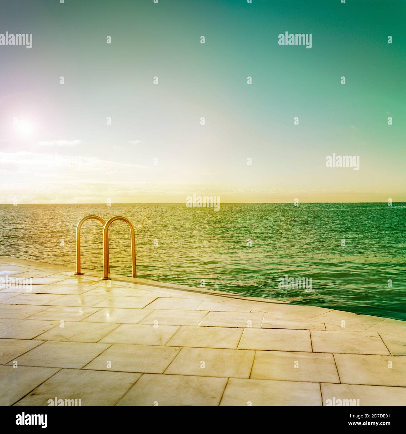 Seascape in front of swimming sea-pool border. Warm stylized edition adding vintage look. Stock Photo