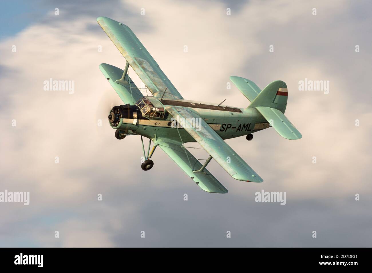 Soviet airplane Antonov An-2 flying with clouds in background Stock Photo