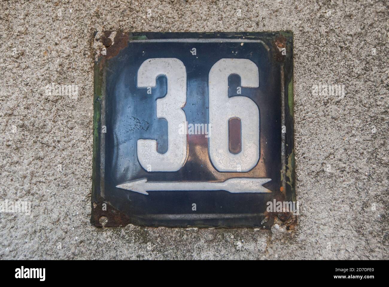 Weathered grunge square metal enameled plate of number of street address with number 36 Stock Photo