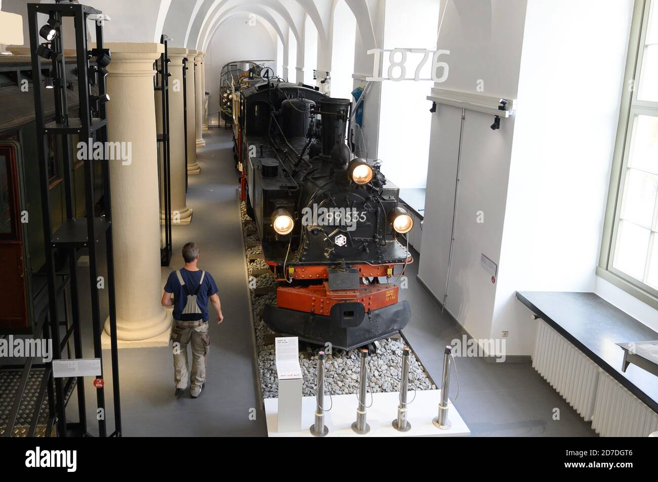 Dresden, Germany. 22nd Oct, 2020. An employee walks along the steam locomotive type IVK in the exhibition 'Abfahrt!' in the Transport Museum. From 23 October 2020, the permanent exhibition shows the development of rail transport in eastern Germany since 1830. Credit: Sebastian Kahnert/dpa-Zentralbild/dpa/Alamy Live News Stock Photo