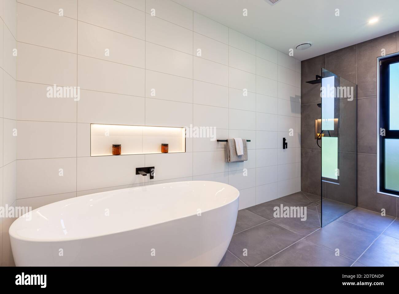 Modern white bathtub and shower interior design Stock Photo - Alamy