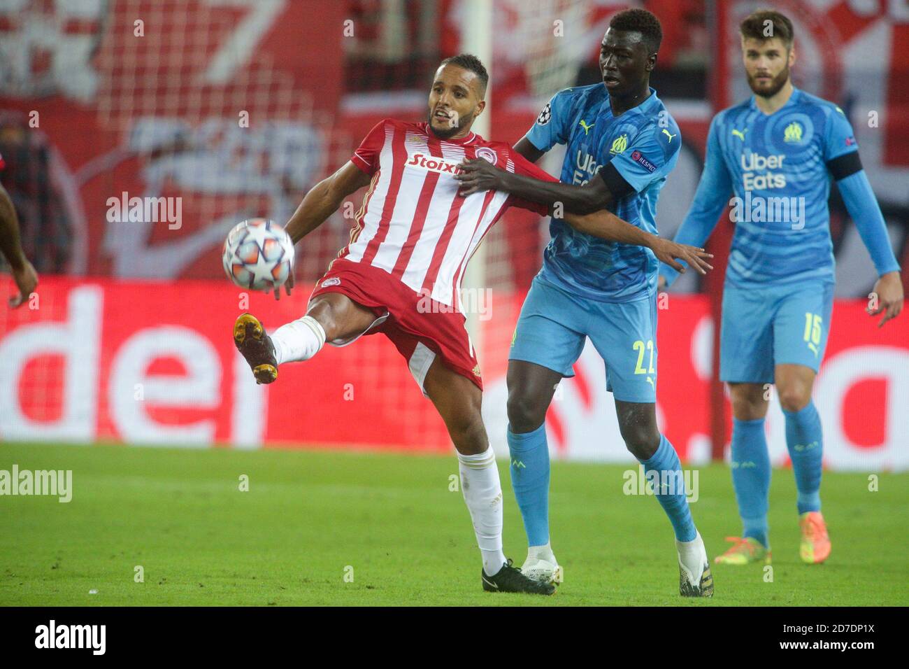 PIRAEUS, GREECE - OCTOBER 21: Youssef El-Arabi of Olympiacos FC controls  the ball in front of Pape Gueye of Olympique de Marseille during the UEFA  Champions League Group C stage match between