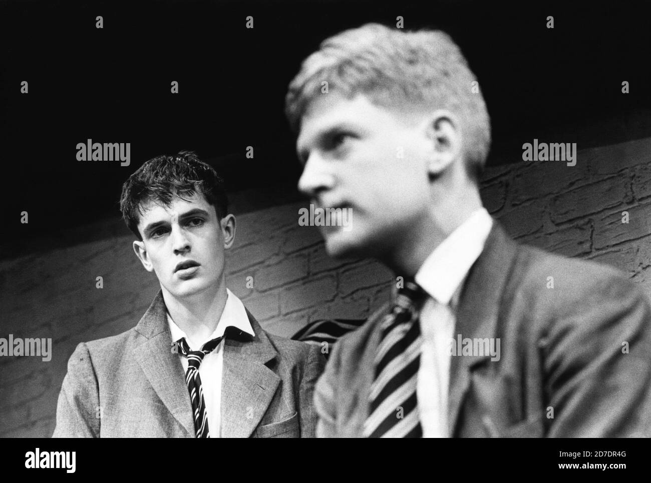 l-r: Rupert Everett (Guy Bennett), Kenneth Branagh (Tommy Judd) in ANOTHER COUNTRY by Julian Mitchell at the Queen's Theatre, London W1  02/03/1982  a Greenwich Theatre 1981 production  design: Bernard Culshaw  lighting: Leonard Tucker  director: Stuart Burge Stock Photo