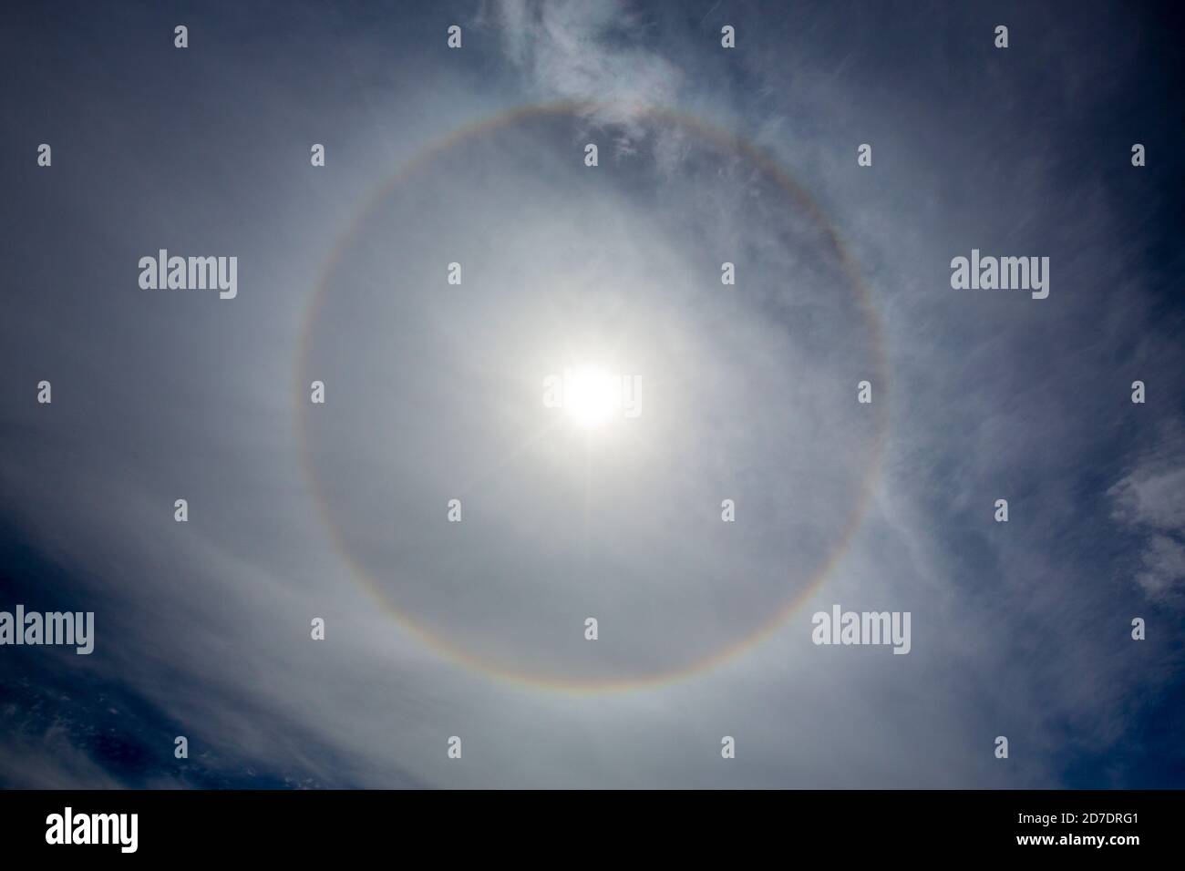 A rainbow around the sun caused by refraction off ice crystals in the upper atmosphere. Stock Photo