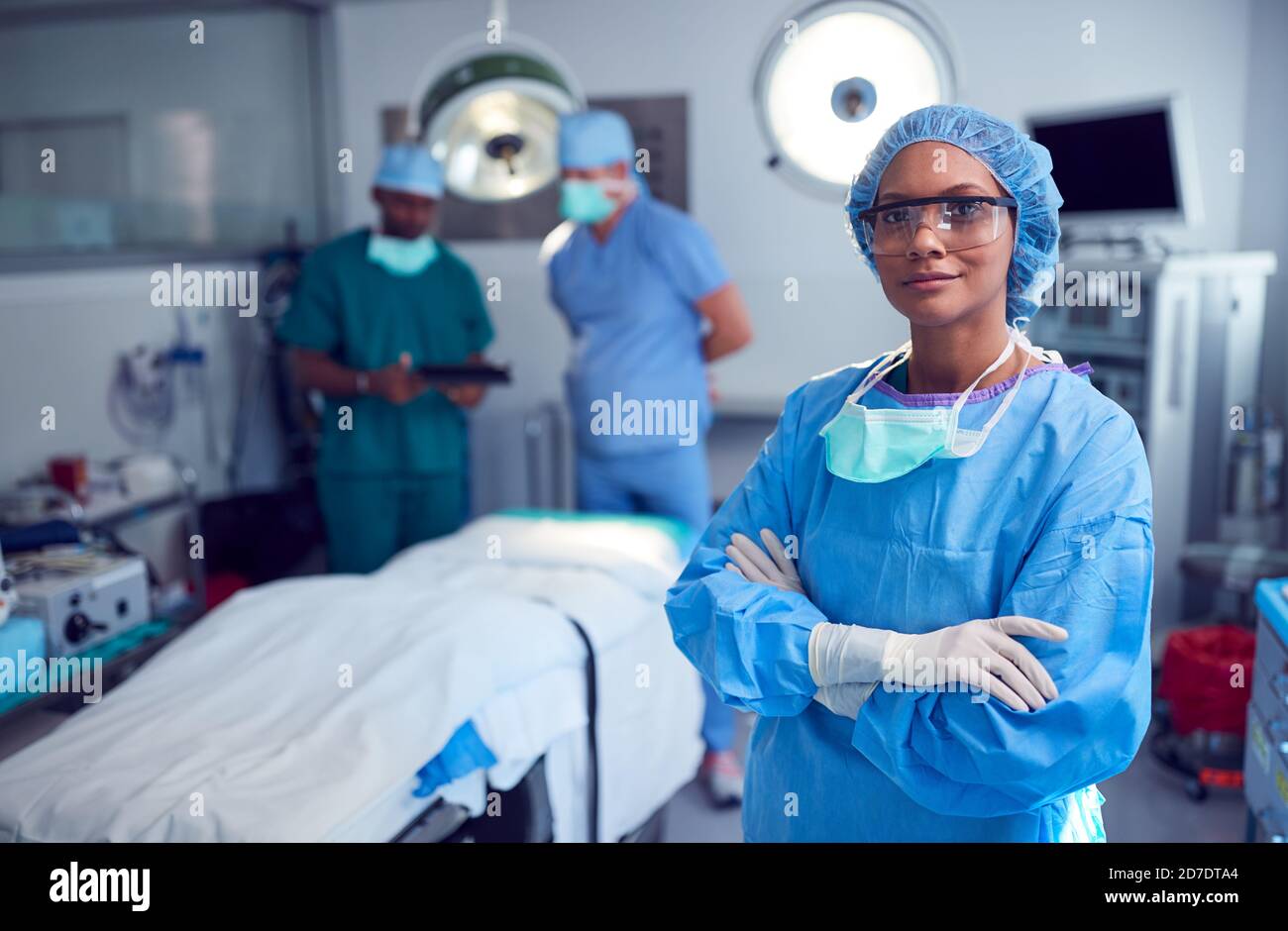 Portrait Of Female Surgeon Wearing Scrubs And Protective Glasses In