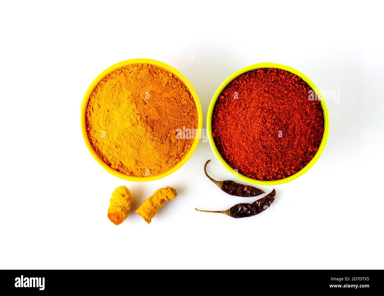 Indian spices Turmeric roots with turmeric powder and red chilly with powder on white background Stock Photo