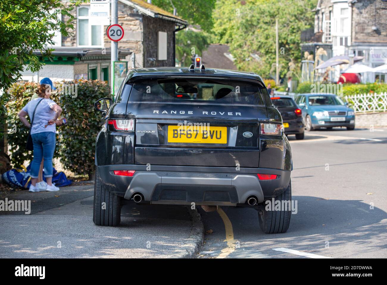 Visitors parking on yellow lines and blocking the pavement in Ambleside, Lake Dsitrict, UK. Stock Photo