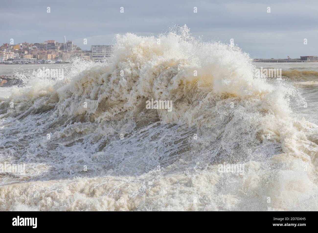 Powerful ocean wave breaking ina windy day in Spanish town Palamos in Costa Brava. Selective focus. Stock Photo