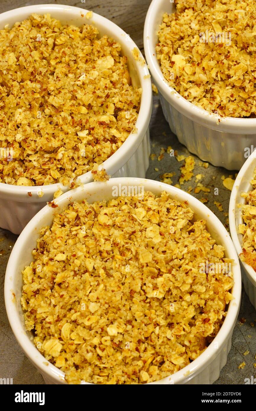 Apple and oat crumbles in individual ramekins Stock Photo Alamy