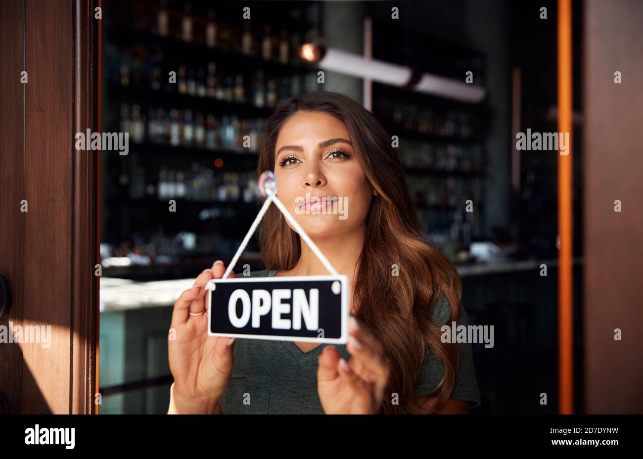 Female Owner Of Start Up Coffee Shop Or Restaurant Turning Round Open