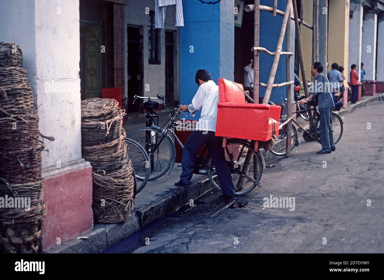 Carrying red chair on bycycle, Nanking, China, 1980s Stock Photo