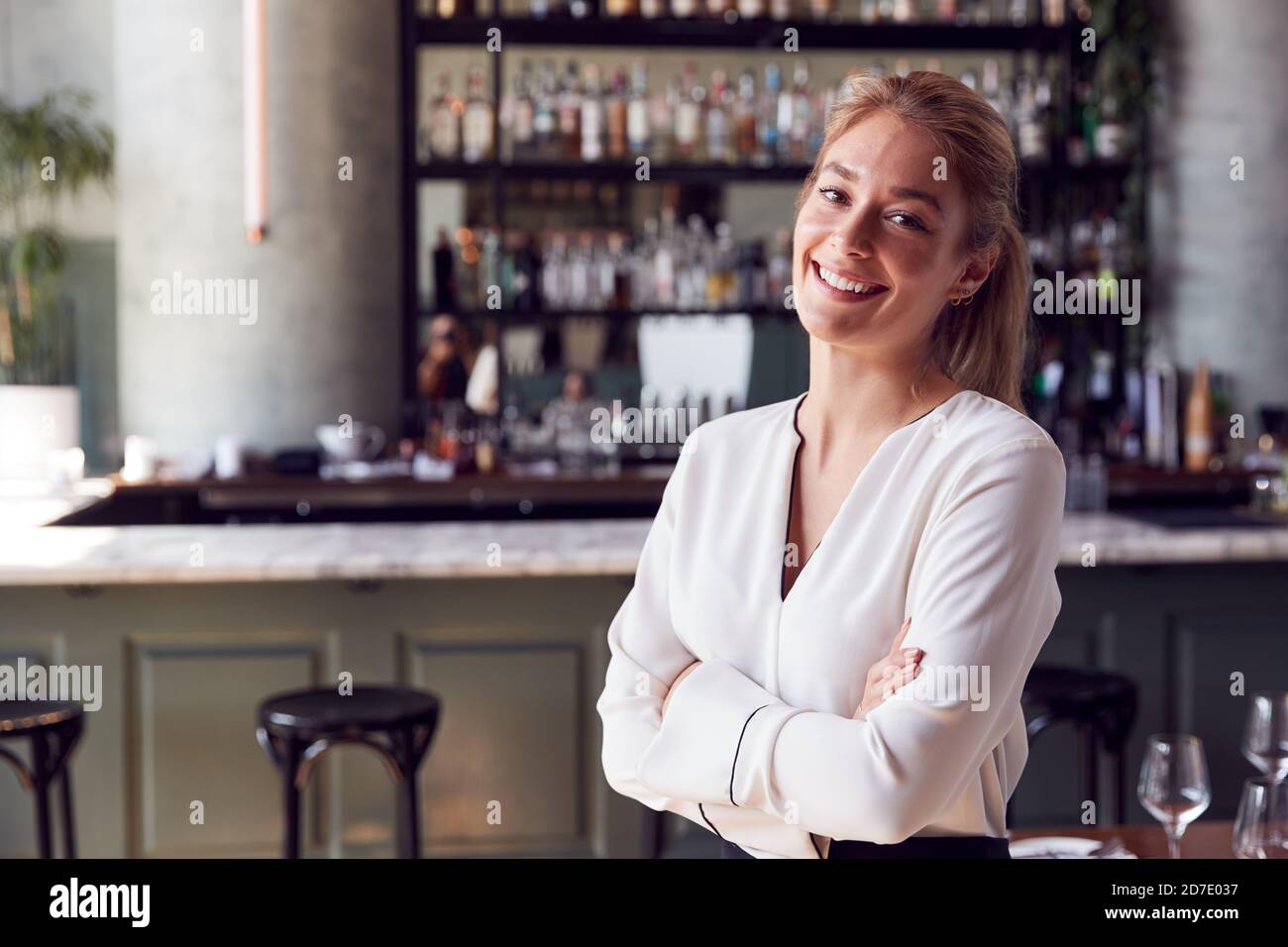 Portrait Of Confident Female Owner Of Restaurant Bar Standing By
