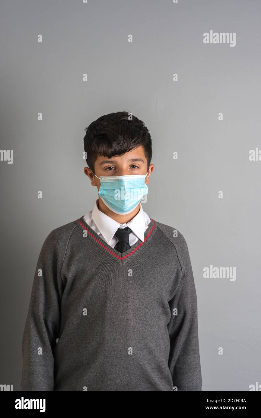 Year 8 UK schoolboy in school unifirm and facemask,UK, Surrey Stock Photo