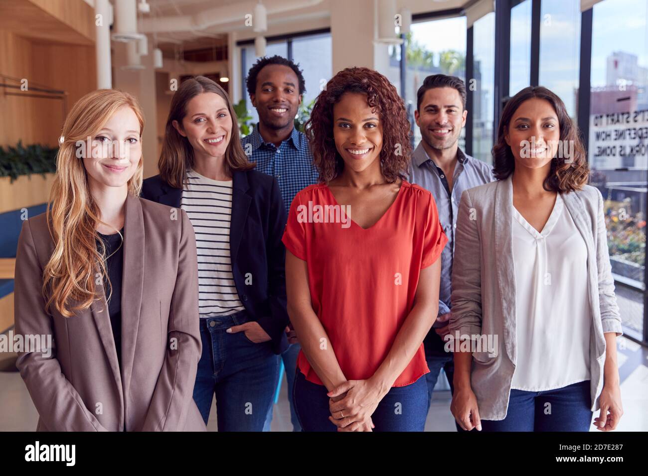 Portrait Of Multi-Cultural Business Team Standing In Modern Open Plan ...