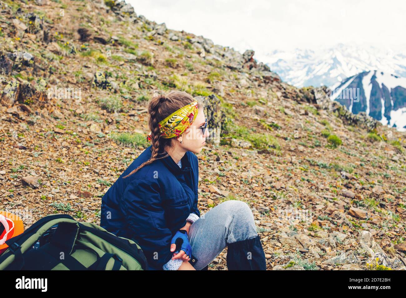 Woman traveler hiking in mountains sitting camping with backpack Travel Lifestyle adventure concept active summer vacations outdoor mountaineering Stock Photo