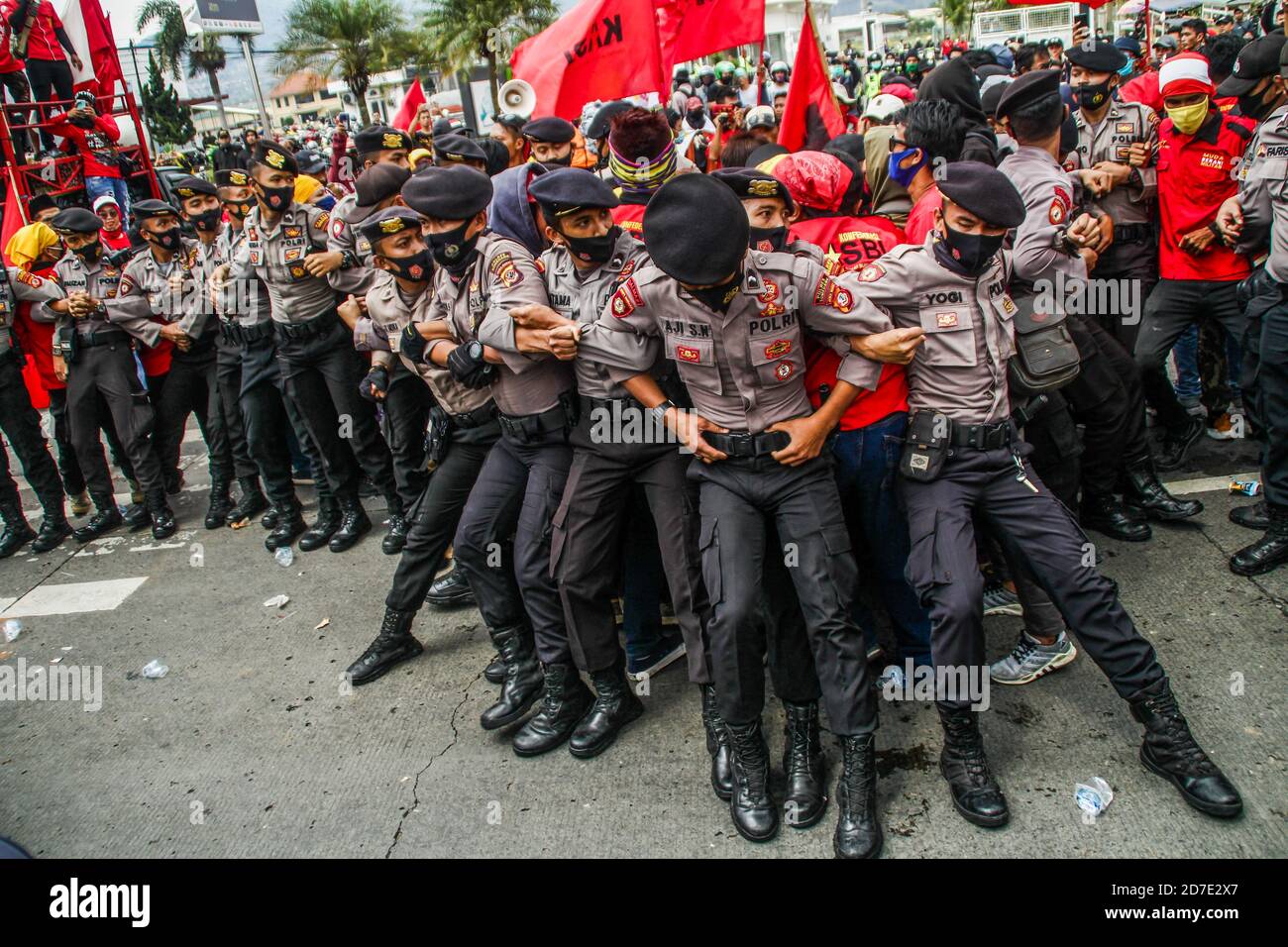 Riot police officers wearing masks stand on guard to make barricades ...