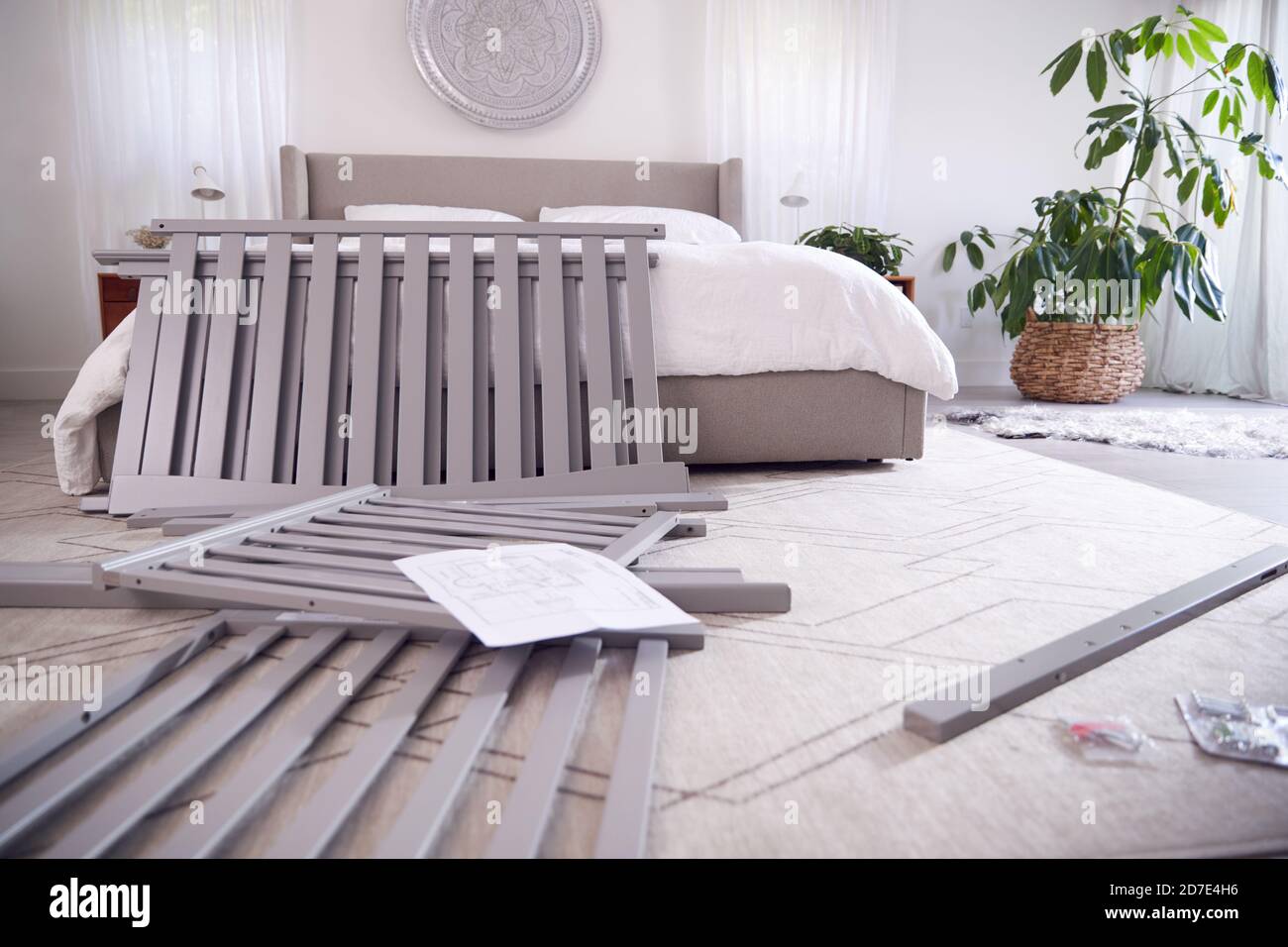 Instructions And Components For Self Assembly Baby Cot On Bedroom Floor