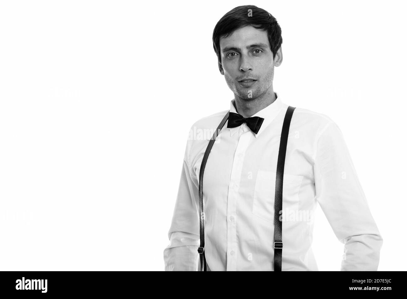 Studio shot of young handsome man wearing suspenders and bow tie Stock Photo