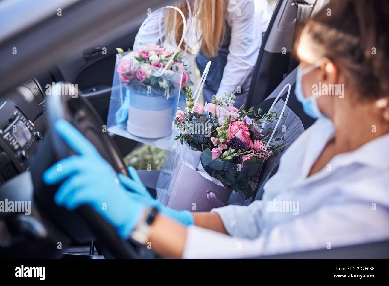 Professional female florist on a flower delivery duty Stock Photo