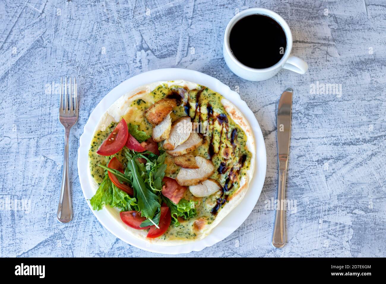 Italian breakfast with coffee. Piadina with grilled chicken, tomatoes, salad and arugula. Delicious breakfast. Soft focus. Top view Stock Photo