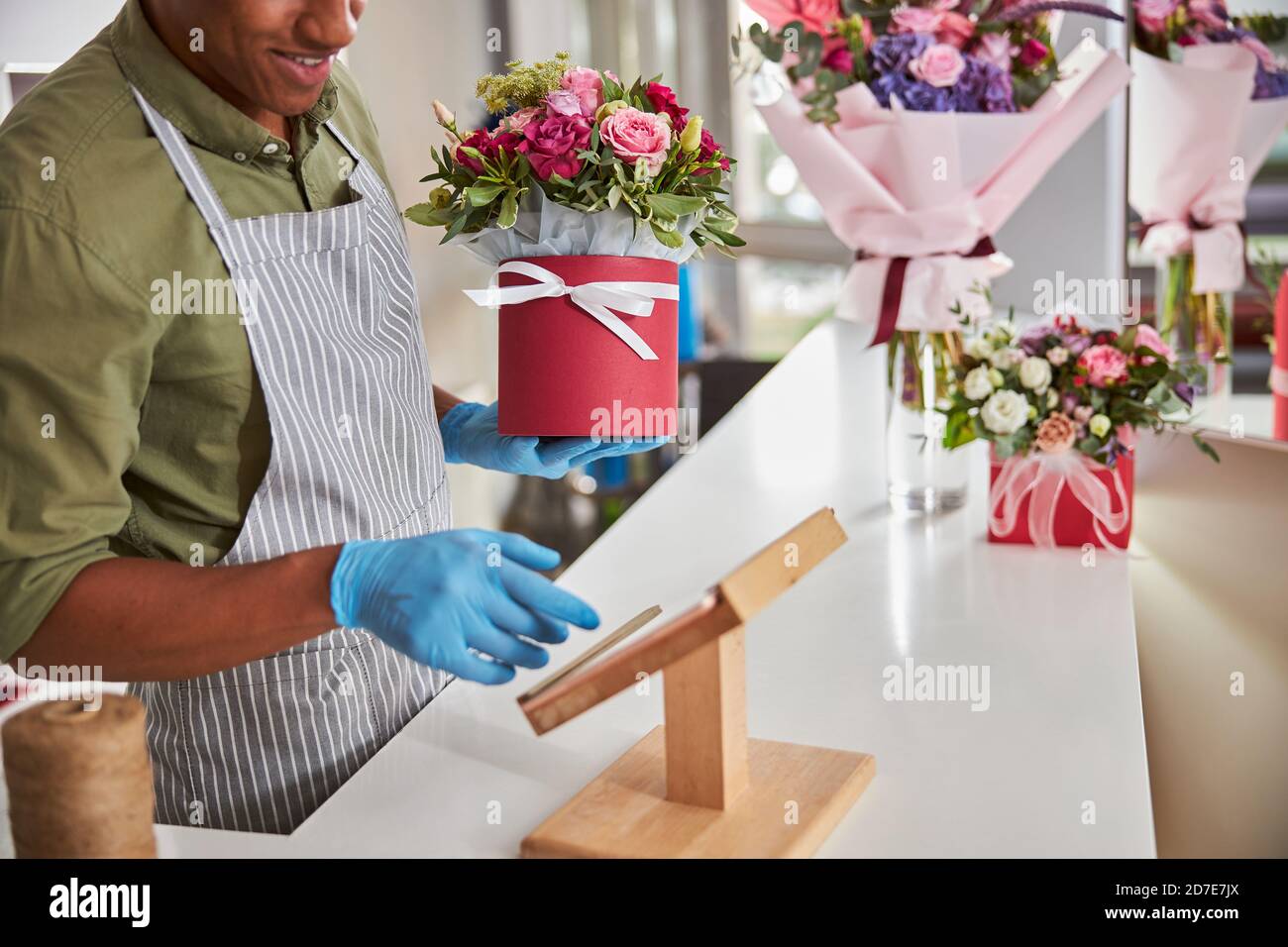 Carefree flower shop assistant using a tablet Stock Photo