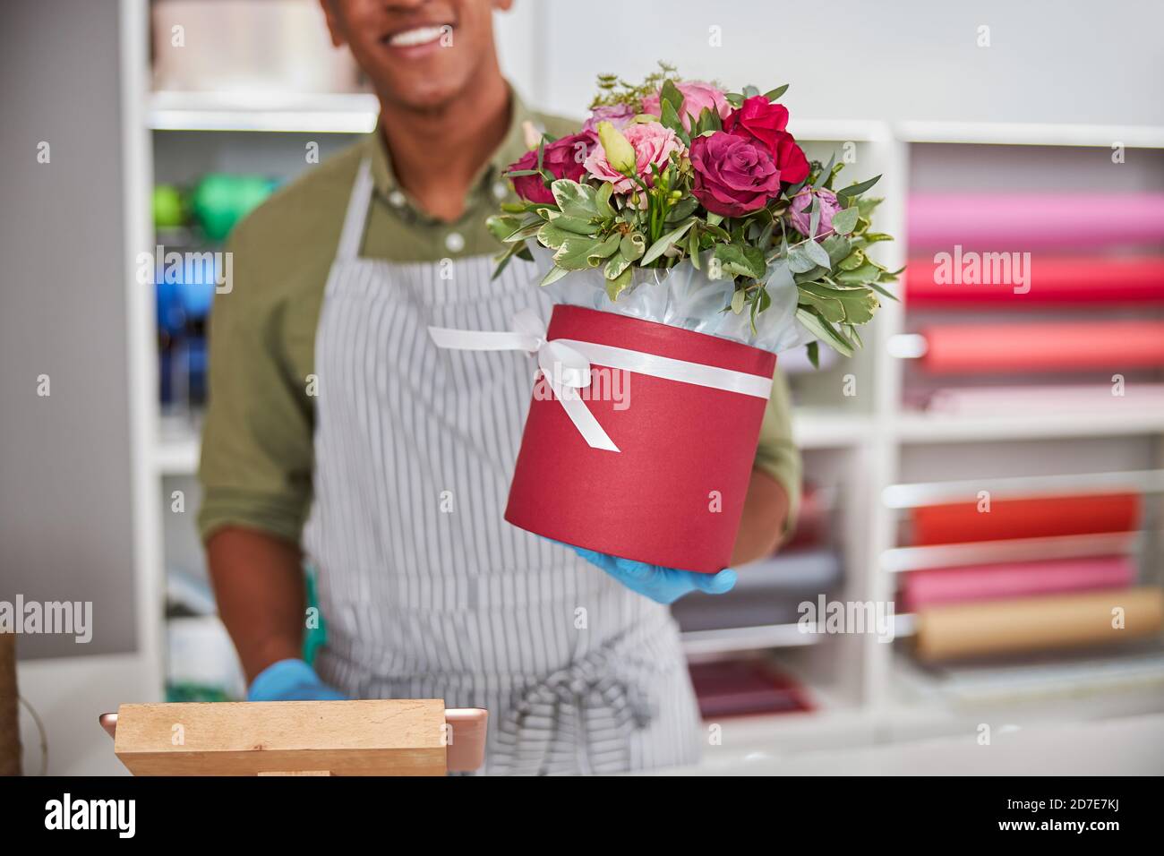 Flower store shopkeeper selling a roses pot Stock Photo Alamy