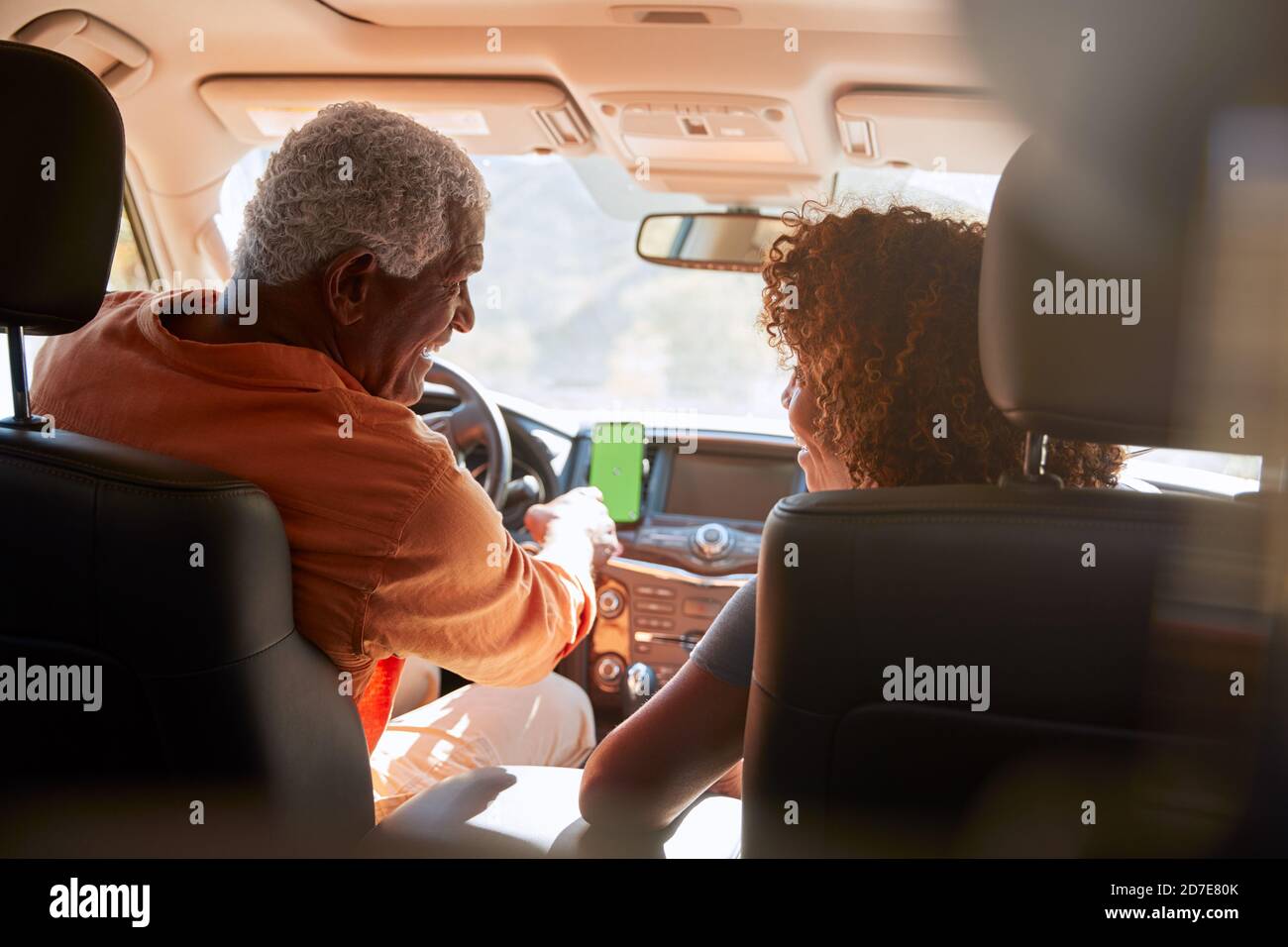 Senior African American Couple On Drive Through Countryside Using Sat Nav On Mobile Phone Stock Photo