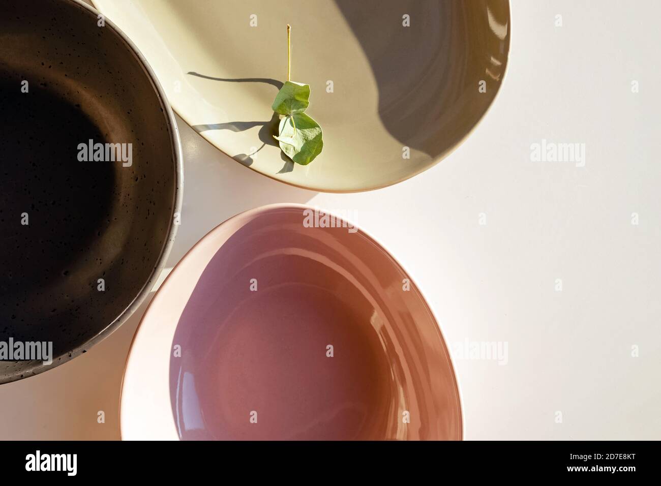 Modern design plates ofpastel colors in natural sunlight, top view Stock Photo