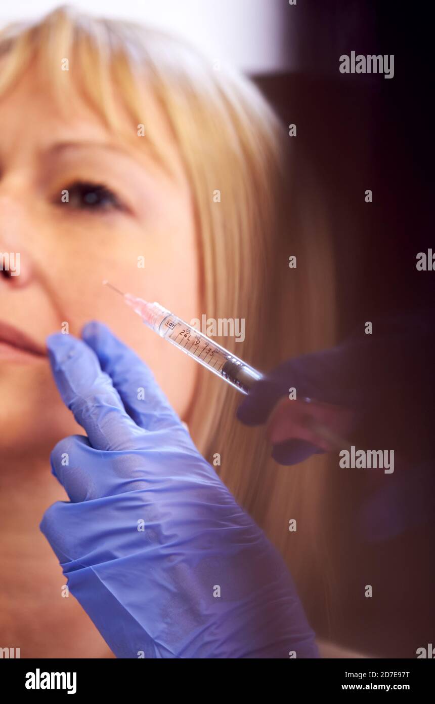 Close Up Of Mature Woman Sitting In Chair Being Give Botox Injection By ...